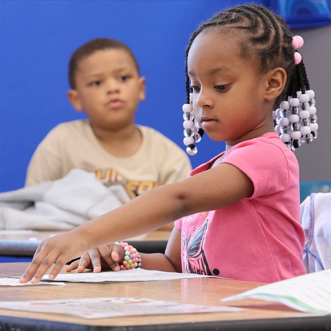  A young student turns a paper at her desk